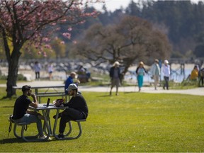 People soak up the sun in West Vancouver, April 2021.