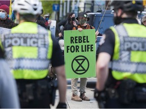 Dozens of Extinction Rebellion members and supporters occupied the intersection of Granville and Georgia Streets in downtown Vancouver on Saturday.