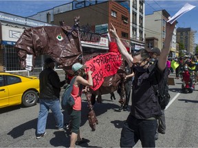 Several dozen protestors march through the Downtown Eastside of Vancouver, BC Tuesday, May 11, 2021 calling for a safe supply of street drugs.