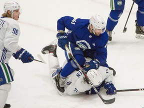Vancouver Canucks  Jonah Gadjovich rides on Zack MacEwen during scrimmage game at Rogers Arena in Vancouver, BC, January 6, 2021.