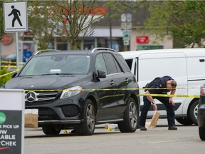 Police investigate a shooting in the Willowbrook Shopping Mall parking lot in Langley, BC, May 3, 2021.