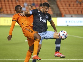 Whitecaps striker Lucas Cavallini (right) fends off Houston Dynamo midfielder Boniek Garcia during their May 22 MLS game in Houston, a 2-1 Dynamo victory. Cavallini is expected to be be paired up top with Brian White again in the Caps’ revised 3-4-1-2 formation.