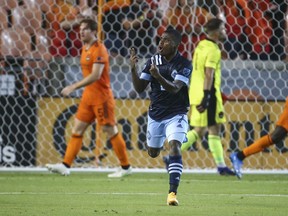 After scoring against the Houston Dynamo, Vancouver Whitecaps FC forward Deiber Caicedo holds up three fingers to denote the score as he tries to encourage his team to keep fighting during Saturday night's game at at BBVA Stadium in Houston.