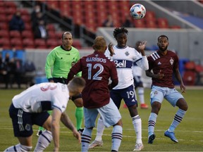 Vancouver Whitecaps midfielder Janio Bikel (19) clears the ball against Colorado Rapids forward Michael Barrios (12) in the first half at Rio Tinto Stadium.