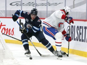 Andrew Coppof the Winnipeg Jets moves the puck past Ben Chiarot of the Montreal Canadiens in Game Two of the Second Round of the 2021 Stanley Cup Playoffs on June 4, 2021 at Bell MTS Place in Winnipeg, Manitoba, Canada.