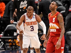 Chris Paul #3 of the Phoenix Suns celebrates towards Will Barton #5 of the Denver Nuggets after scoring off a turnover in Game Four of the Western Conference second-round playoff series at Ball Arena on June 13, 2021 in Denver, Colorado.