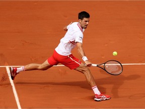 Novak Djokovic plays a backhand in his men's singles fourth-round match against Lorenzo Musetti during Day 9 of the 2021 French Open at Roland Garros on June 7, 2021 in Paris, France.