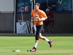 Tom Brady #12 of the Tampa Bay Buccaneers runs out to the field during the Buccaneers Mini-Camp at AdventHealth Training Center on June 08, 2021 in Tampa, Florida.