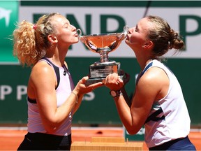 Katerina Siniakova and Barbora Krejcikova of The Czech Republic pose with the trophy after winning their Women's Doubles Final match against Bethanie Mattek-Sands of The United States and Iga Swiatek of Poland during Day Fifteen of the 2021 French Open at Roland Garros on June 13, 2021 in Paris, France.