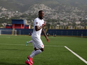 Cyle Larin celebrates his goal against Haiti in the first half of Saturday's game in Port-au-Prince. Canada won 1-0.