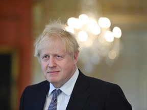 Britain's Prime Minister Boris Johnson listens during a press conference following a meeting inside 10 Downing Street in London on June 2, 2021.