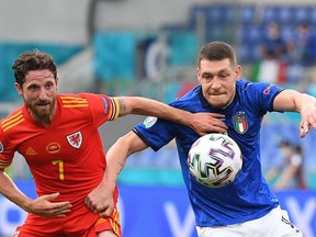 Italy's forward Andrea Belotti, right, battles for the ball with Wales midfielder Joe Allen during the UEFA Euro 2020 Group A football match between Italy and Wales at the Olympic Stadium in Rome on June 20, 2021.