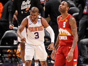 Chris Paul of the Phoenix Suns celebrates as Will Barton of the Denver Nuggets looks on at Ball Arena on June 13, 2021 in Denver, Colorado.