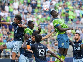 Seattle Sounders Abdoulaye Cissoko, second from right, puts a header on goal but the shot is just right of the net in the first half of an MLS soccer match against the Vancouver Whitecaps, Saturday, June 26, 2021, in Seattle.