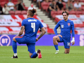 England defender Declan Rice, left, and striker Jack Grealish take a knee ahead of the international friendly football match between England and Romania in Middlesbrough, England on June 6, 2021.
