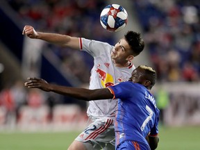 Brian White #42 of New York Red Bulls and Roland Lamah #7 of FC Cincinnati battle for the ball in the second half at Red Bull Arena on April 27, 2019 in Harrison, New Jersey. White was traded to the Vancouver Whitecaps at the transfer window deadline on Tuesday in exchange for $400,000 in GAM.