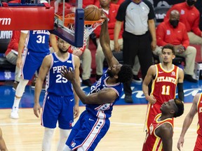 Philadelphia 76ers centre Joel Embiid dunks the ball in front of Atlanta Hawks centre Clint Capela during the second quarter in Game 2 of the second round of the 2021 NBA Playoffs at Wells Fargo Center in Philadelphia, June 8, 2021.