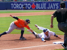 Alex Bregman of the Houston Astros tags out Danny Jansen of the Blue Jays at third base during the third inning at Sahlen Field on Sunday, June 6, 2021 in Buffalo.