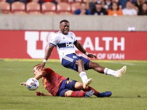 Real Salt Lake defender Erik Holt (20) kicks the feet out from under Vancouver Whitecaps forward Cristian Dajome (11) during the second half at Rio Tinto Stadium. Real Salt Lake won 3-1.