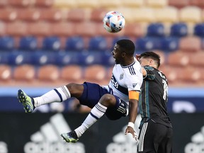 Vancouver Whitecaps forward Cristian Dajome (11) and Los Angeles Galaxy defender Jorge Villafana (19) battle for a ball in the first half at Rio Tinto Stadium.