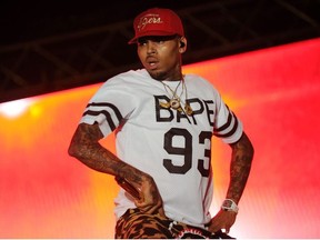 This file photo taken on June 26, 2015 shows singer Chris Brown performing during a free concert in Champ de Mars, downtown Port-au-Prince, Haiti. A Los Angeles woman filed a lawsuit on Wednesday, May 9, 2018 against Chris Brown and a fellow rapper, alleging she was repeatedly raped and sexually assaulted at Brown's home during a drug- and alcohol-fueled party last year. The woman, identified only as Jane Doe, said she was lured to the singer's house following a concert at a nightclub on February 23, 2017 and was raped several times by Lowell Grissom, who performs under the name Young Lo.