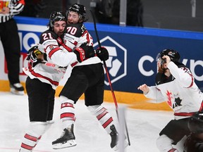 Canada's forward Nick Paul celebrates scoring the winning 3-2 goal with teammate Troy Stecher during the IIHF Men's Ice Hockey World Championships final between Finland and Canada in Riga, Latvia, on June 5.