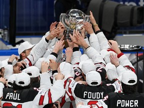Canadian players celebrate Sunday's 3-2 overtime victory over Finland in the gold-medal final at the IIHF world men's hockey championship in Riga, Latvia.