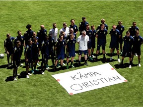 Sweden's players pose with a banner displaying a message in support to Denmark's midfielder Christian Eriksen, who was hospitalized after he collapsed on the pitch during the UEFA EURO 2020 Group B football match against Finland the night before, prior to an MD-1 training session at La Cartuja Stadium in Sevilla on June 13, 2021, on the eve of their UEFA EURO 2020 Group E football match against Spain.