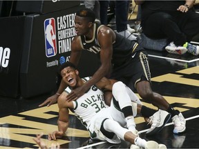 Jun 29, 2021; Atlanta, Georgia, USA; Milwaukee Bucks forward Giannis Antetokounmpo (34) and Atlanta Hawks center Clint Capela (15) fall to the floor as Antetokounmpo (34) is injured on the play in the third quarter during game four of the Eastern Conference Finals for the 2021 NBA Playoffs at State Farm Arena.
