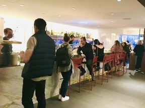 Customers enjoy the Giovane Bacaro counter in the Fairmont Pacific Rim Hotel. There is high-top seating in one area, a standing counter down the middle, a bar seating facing a 40-tap Enomatic wine system and a more private dining area at the back.