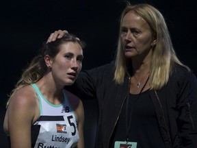 Lindsey Butterworth of Canada is comforted by her coach Brit Townsend following the women's 800 metre race during the 2019 Harry Jerome International Track Classic in Burnaby.