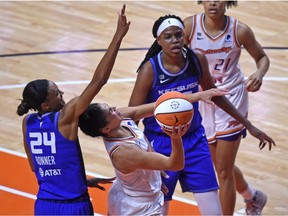 Phoenix Mercury guard Kia Nurse (0), center, drives to the basket between Connecticut Sun forward DeWanna Bonner (24), left, and Connecticut Sun forward Jonquel Jones (35) in the home opener Sunday, May 16, 2021, in Uncasville, Conn.