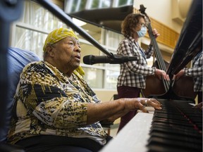 Eve Duke, backed-up by standup bassist Wendy Solloway and drummer Paul Adams, not pictured, plays the grand piano at St. Vincent's Langara care home in Vancouver on June 10.