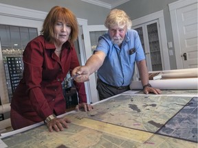Richard Wright and Amy Newman looking over maps of where the Cariboo Waggon Road was located.
