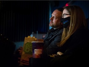 Gabe Dennis and his partner were among the crowd watching Cinema Paradiso at The Rio Theatre in East Vancouver on Tuesday, as movie theatres reopened with limited seating and COVID-19 safety protocols.