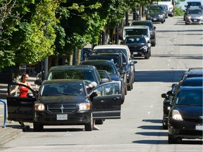 Cars parked on Robson street in downtown Vancouver. A proposal for citywide parking permits may be difficult to enforce.