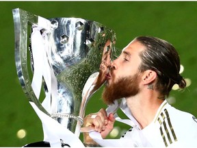 Real Madrid's Sergio Ramos celebrates with the trophy after winning La Liga.