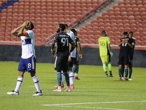 Vancouver Whitecaps midfielder Caio Alexandre holds his head in disbelief as he walks off the field after the Los Angeles Galaxy won 2-1 at Rio Tinto Stadium Wednesday night.