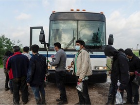 Central American migrants make a line to board a bus to be transported by U.S. Border Patrol agents after crossing the Rio Grande river into the United States from Mexico, in La Joya, Texas, U.S., June 8, 2021.