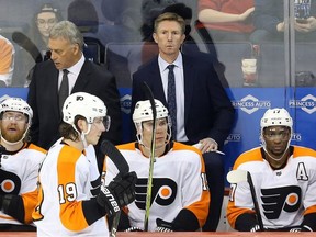 Philadelphia Flyers head coach Dave Hakstol stares blankly late in a 7-1 loss to the Winnipeg Jets in Winnipeg on Sun., Dec. 9, 2018.