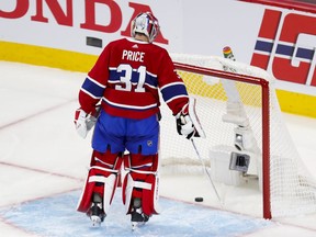 Canadiens' Carey Price fishes the puck out of his net after a goal by Lightning's Victor Hedman during the first period of Game 3 of teh Stanley Cup final Friday night at the Bell Centre.