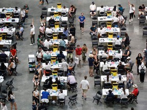 People receive a dose of the COVID-19 vaccine at a mass vaccination clinic at Scotiabank Arena in Toronto on Sunday, June 27, 2021.