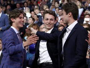 Luke Hughes (centre) will join his brothers Jack (left) and Quinn as first round NHL draft picks on Friday. Just where the defenceman goes in the first round is anyone's guess at this point.