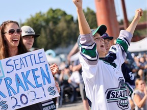 Jennifer Lang and her sons, including Jessie Lang (R), applaud as the first picks are made at the Seattle Kraken 2021 NHL expansion draft at Gas Works Park on July 21, 2021 in Seattle, Washington.