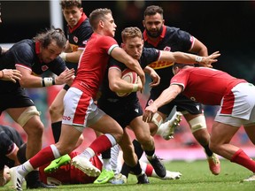 Wales scrum half Kieran Hardy gets to grips with Canada player Cooper Coats during the International Match between Wales and Canada at Principality Stadium on July 03, 2021 in Cardiff, Wales.