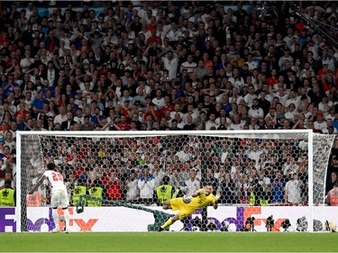 Bukayo Saka of England misses his team's fifth penalty in a penalty shoot out which is saved by Gianluigi Donnarumma of Italy during the penalty shoot out in the UEFA Euro 2020 Championship Final between Italy and England at Wembley Stadium on July 11, 2021 in London, England.