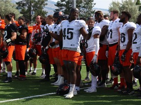 Defensive lineman Tim Bonner leads the defence in the singing of O Canada at B.C. Lions training camp in Kamloops.