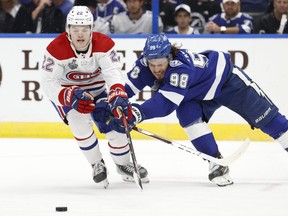 Lightning defenceman Mikhail Sergachev chases the puck against Canadiens right winger Cole Caufield during the third period of Game 2.