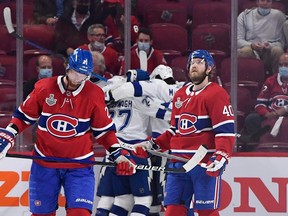 Canadiens' Eric Staal (left) and Joel Armia look on dejectedly as the Lightning celebrates its third-period goal on Friday night that all but seals Montreal's fate in the Stanley Cup final.