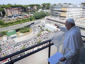 A photograph on July 11, 2021 shows Pope Francis leading the Sunday's Angelus prayer from the balcony of his room, at the Gemelli Hospital, in Rome, where he is recovering from colon surgery.